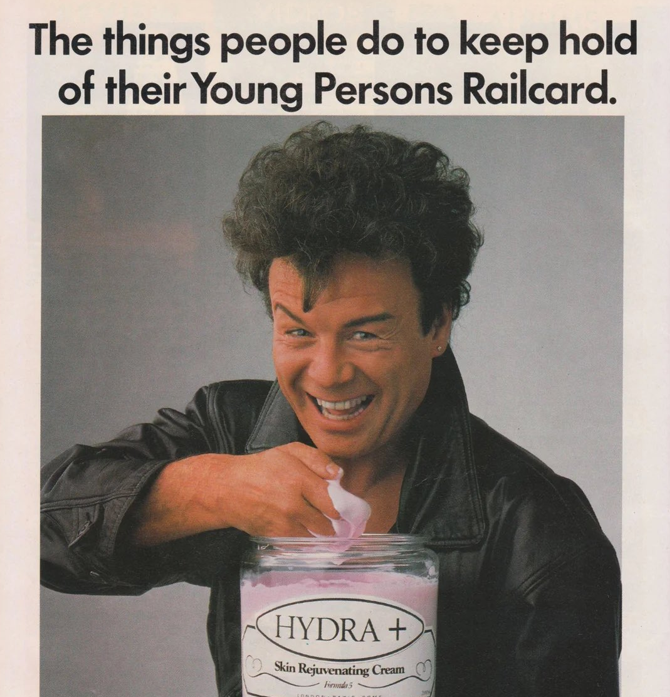 A man with curly hair in a leather jacket smiles while preparing to apply cream from a jar labeled 'HYDRA + Skin Rejuvenating Cream'. The text above reads, 'The things people do to keep hold of their Young Persons Railcard.'